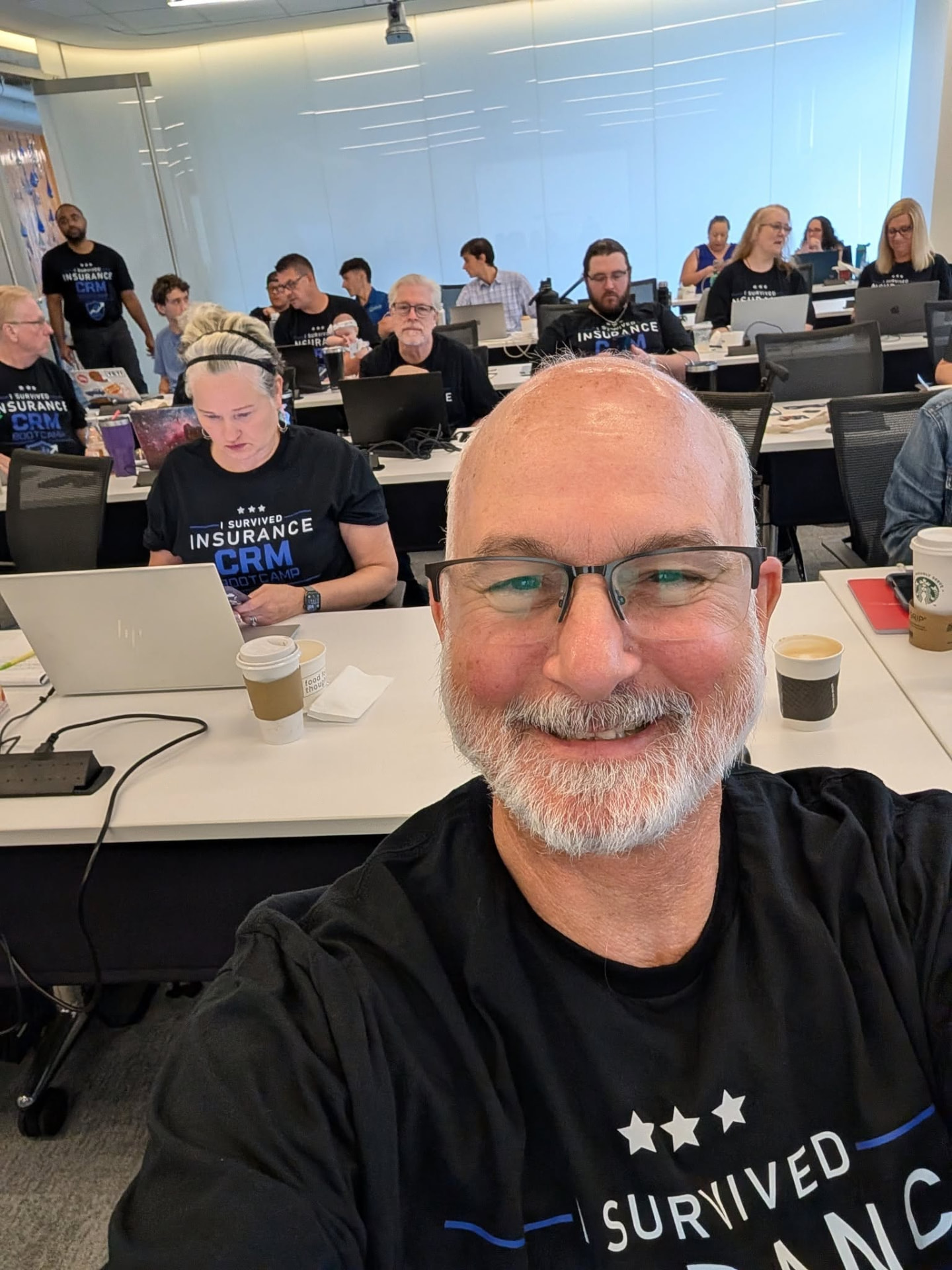 Full room of insurance agents building their CRM together