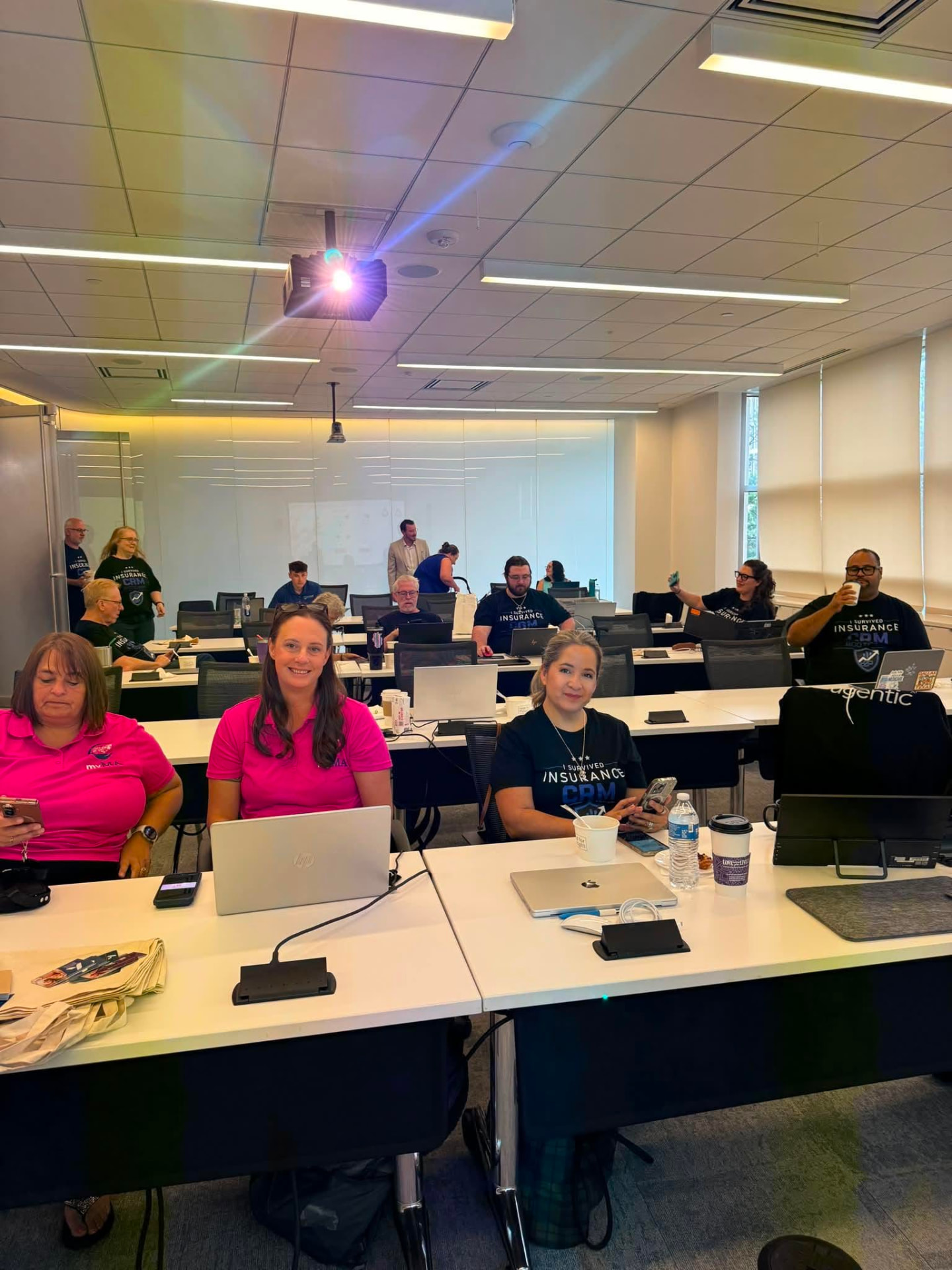 Classroom of agents at their laptops during a live CRM build session