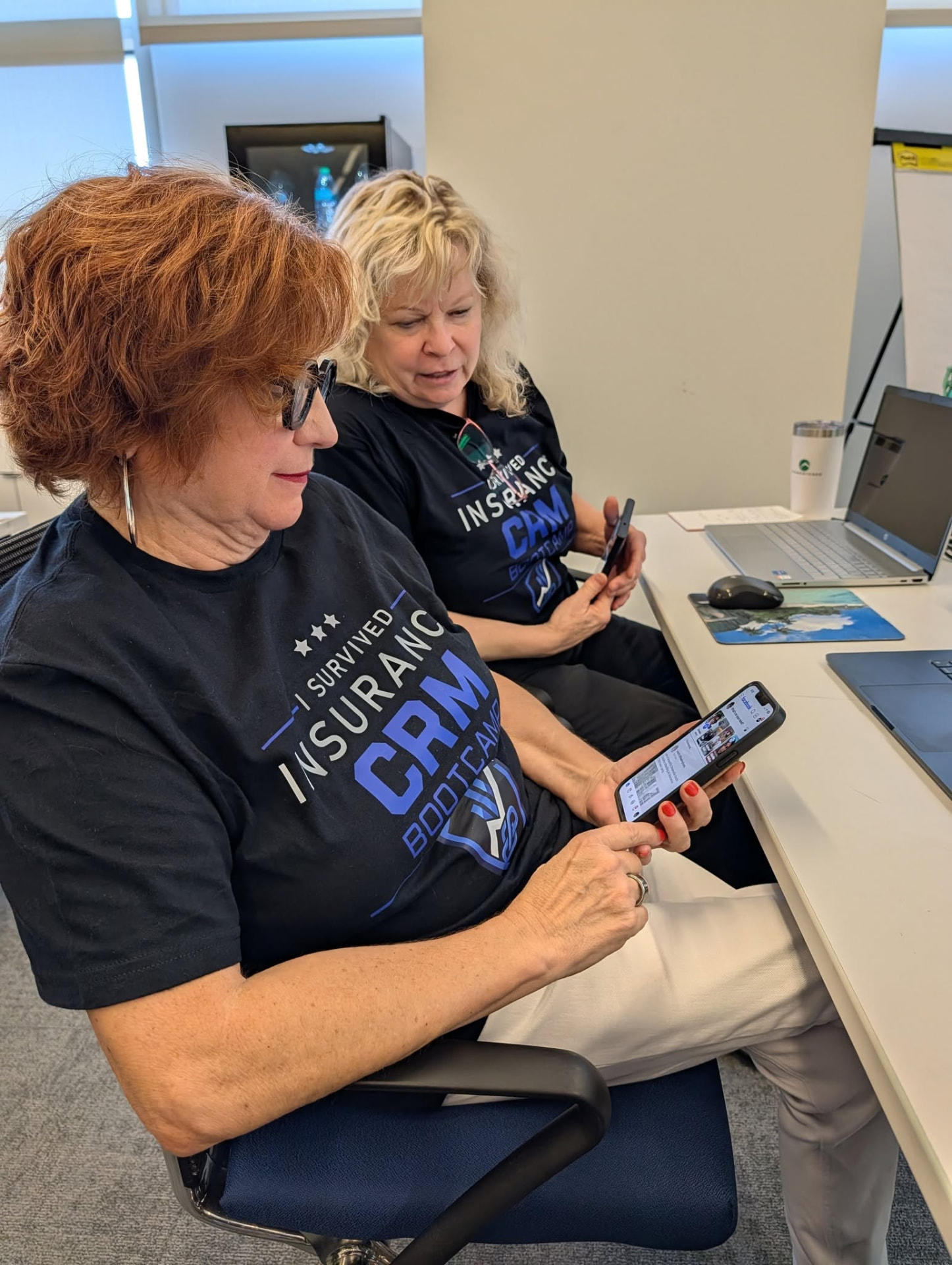 Two attendees testing their new CRM automations on their phones